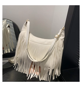 Détail du sac à main blanc en cuir grainé avec longues franges et boucles dorées