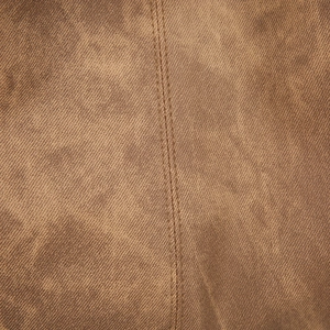 Detailed macro view of the brown faux leather fabric texture and vertical double stitching