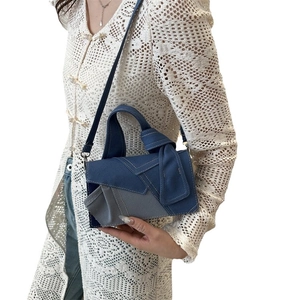 Patchwork denim shoulder bag with contrast stitching and flap closure for casual style