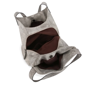 Detail view of large grey tote bag showing spacious multi-compartment interior and magnetic clasp