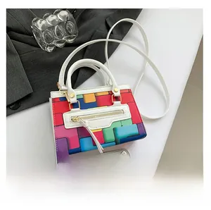 Size comparison of the mini crossbody bag with colorful geometric blocks and a smartphone