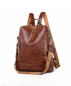 Side view of vintage brown PU leather backpack with cracked texture and gold hardware