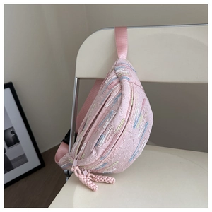 Détail du sac banane rose brodé avec texture matelassée et tirette de zip tressée