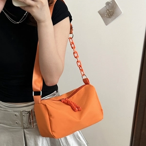 Orange nylon shoulder bag with large acrylic chain and adjustable strap for women