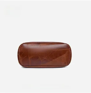 Detailed bottom view of vintage brown PU leather backpack with geometric stitching