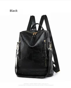 Detail of black PU leather backpack showing chic patchwork texture and gold metal zippers