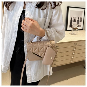 Quilted apricot crossbody bag with gold hardware and mini pouch shown on model