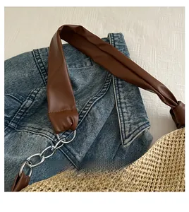 Detail of handwoven straw tote with premium brown leather straps and silver hardware