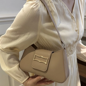 Minimalist beige underarm bag with gold buckle and chain strap for summer style