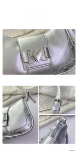 Detail of silver metallic leather underarm bag with heart buckle and rivet studs