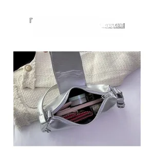 Internal view of silver shoulder bag showing large capacity for phone and cosmetics
