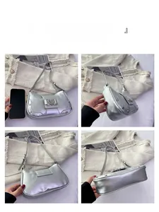 Silver metallic underarm bag details with heart buckle and phone size comparison