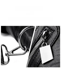 Detail of gunmetal swivel hook and zipper hardware on black lychee leather bag