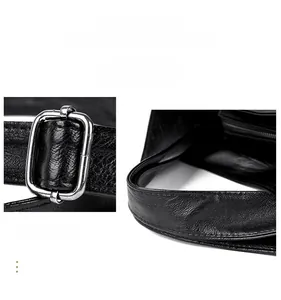 Detail of silver metal buckle and stitch quality on black lychee texture leather bag