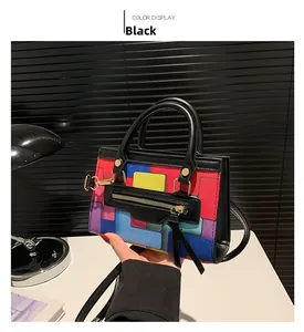 Detail view of colorful geometric patchwork on a textured leather crossbody bag in black