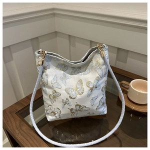 Detailed embroidery of blue butterflies and golden silk on silk shoulder bag