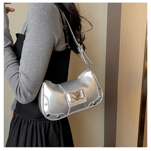 Detail view of silver underarm bag with heart-shaped metal buckle and stud decorations