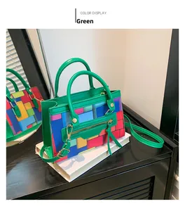 Macro view of geometric color-block handbag with green handle and vibrant leather panels