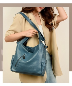 Close-up of blue soft leather hobo bag with zipper detail and large capacity for women