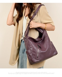 Detail of soft purple leather tote bag with vertical zipper and adjustable shoulder strap
