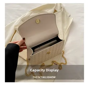 Detail view of woven straw and leather crossbody bag interior showing phone capacity