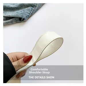 Close-up of a wide comfortable white shoulder strap with fine stitching and soft texture