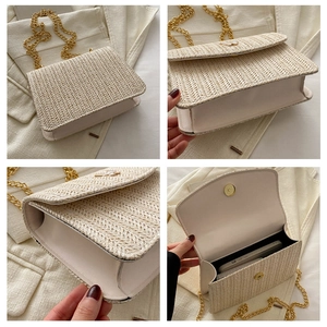 Detail view of woven straw shoulder bag with gold chain and interior phone storage