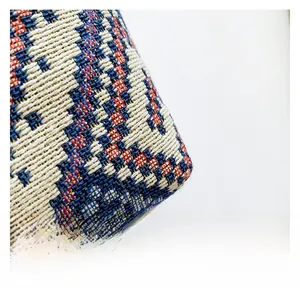 Close-up of bohemian woven canvas tote bag with red and blue geometric patterns