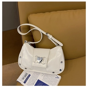 Detail of white patent leather shoulder bag with heart buckle and silver rivets