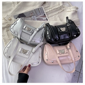 Detail of four colorful Y2K underarm bags with heart metal buckles and rivet accents