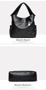 Detail view of the black leather shoulder bag showing back zipper pocket and wide base