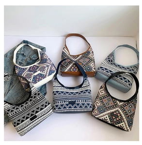 Detailed display of assorted bohemian canvas tote bags with tribal geometric prints