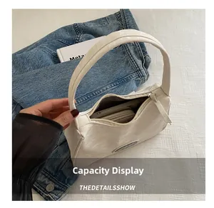 Detailed interior view showing large capacity for phone and wallet in white hobo bag
