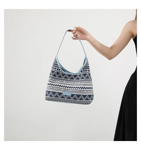 Detailed macro view of the geometric wave pattern and blue canvas trim on this tote bag