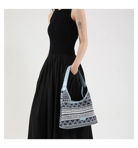 Close-up of bohemian geometric woven pattern canvas tote bag with light blue leather strap