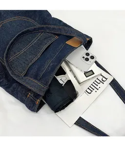 Macro view of denim tote bag interior showing large capacity for umbrella and books