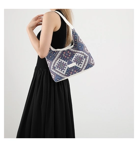 Detailed side view of ethnic woven hobo bag with geometric pattern on female model