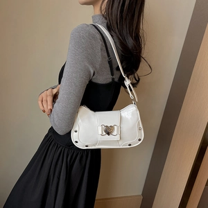 White glossy underarm bag with silver heart buckle and metal rivets for women