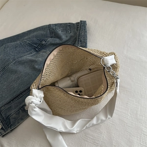 Straw woven tote bag with white leather strap and chain showing spacious interior