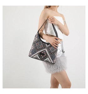 Detailed shot of ethnic tote bag with colorful geometric patterns and leather strap