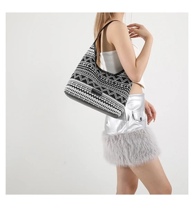 Detail of a large ethnic tote bag with black and white geometric patterns and leather strap