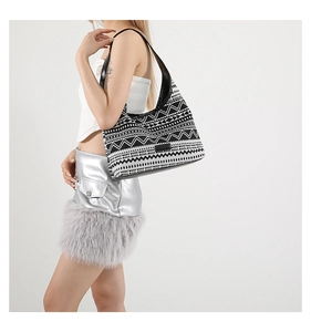 Detail of canvas tote bag with black and white ethnic geometric patterns and fashion tag
