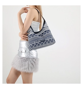 Close-up of geometric pattern jacquard tote bag with black slim shoulder strap