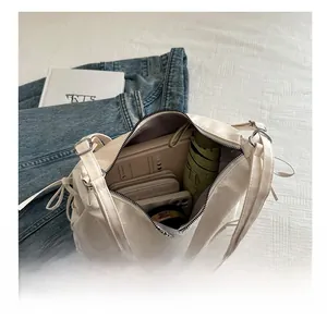 Interior view showing the large storage capacity of this beige leather crossbody bag
