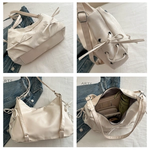 Detailed interior of cream shoulder bag showing large capacity for umbrella and phone