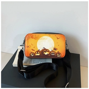 Detail of Halloween square crossbody bag featuring pumpkin prints and wide nylon strap