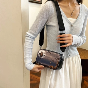 Halloween crossbody bag with festive illustration and black wide shoulder strap on model