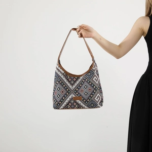 Ethnic woven tote bag with geometric patterns and brown leather straps for daily commute