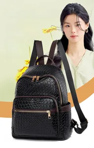 Detail view of large capacity black woven leather backpack with multiple zipper pockets