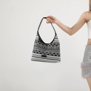 Ethnic style half-moon tote bag with black and white wave pattern and leather handle